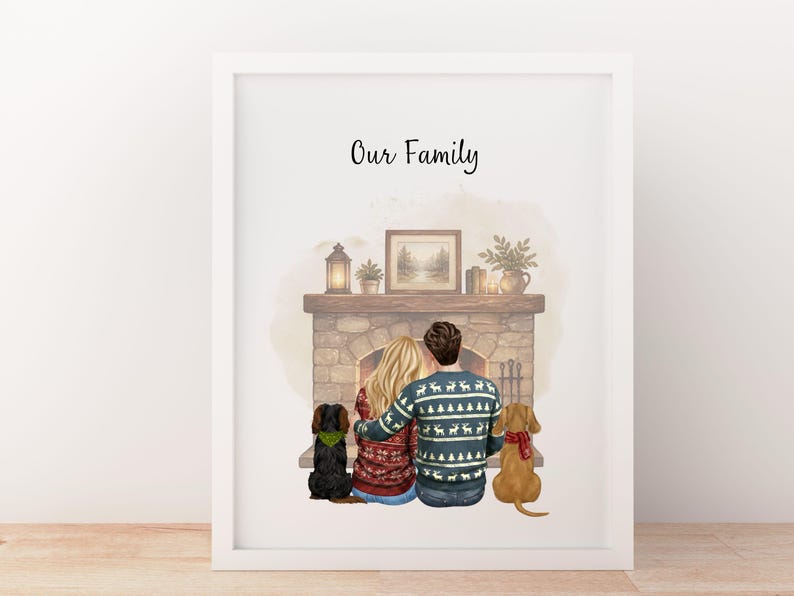 May include: A framed print titled Our Family featuring an illustration of two people sitting before a stone fireplace with two dogs. The people wear patterned sweaters, and the dogs wear scarves. A lantern, plant, and framed picture sit on the mantel.