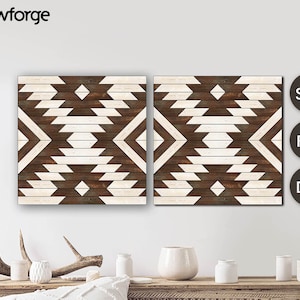 May include: Two brown and white geometric wood wall art panels with a chevron pattern. The panels are hung on a white wall above a wooden table with decorative items.