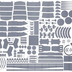 May include: A detailed paper model kit for building a spaceship. The kit includes a variety of parts, including the hull, wings, engines, and landing gear. The parts are printed on a sheet of paper with grey lines and numbers for assembly.