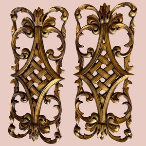 Two baroque style carved wood panels painted gold