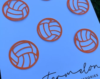 May include: Six orange glitter volleyball cutouts on a white background. The cutouts are approximately 2 inches in diameter. The text "watermelon" and "CUSTOM DESIGNED ACCESSORIES" is written in black at the bottom of the image. The website address "www.watermelonbyclaire.etsy.com" is written in black below the text.