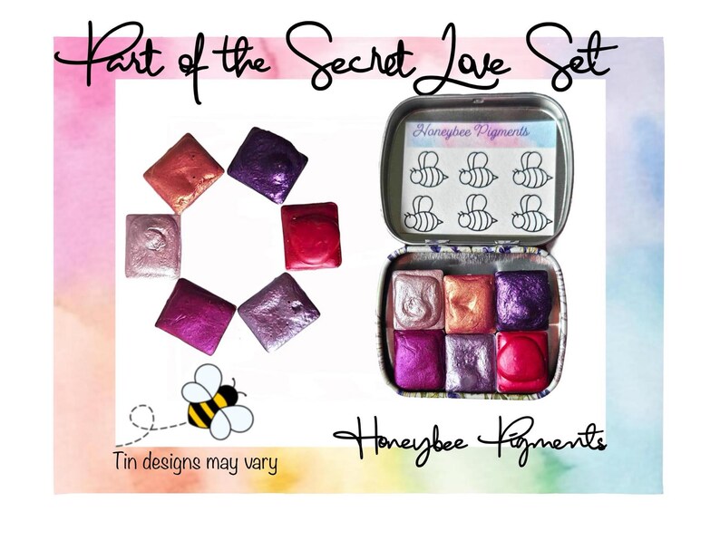 May include: Part of the Secret Love Set watercolor paint set in a tin with a bee design. The set includes six watercolor pans in shades of pink, purple, and red. The tin is labeled "Honeybee Pigments".