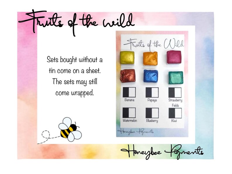 May include: A set of watercolour paints called "Fruits of the Wild" by Honeybee Pigments. The set includes 8 colours: Banana, Papaya, Strawberry Fields, Watermelon, Blueberry, Kiwi, and two other colours. The paints are in small square pans and are arranged in a grid on a white card.