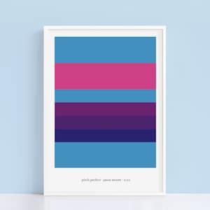 May include: A framed print with a colorful abstract design featuring horizontal stripes in shades of blue, pink, purple, and dark blue. The text "pitch perfect - jason moore - 2012" is printed at the bottom of the print.