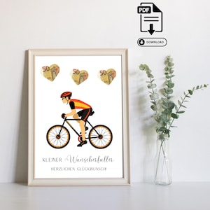 Puede incluir: Impresión enmarcada con un ciclista en negro, naranja y amarillo en bicicleta. Encima del ciclista, tres imágenes en forma de corazón con el número 50. El texto "KLEINER Wunscherfüller HERZLICHEN GLÜCKWUNSCH!" está debajo.