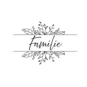 May include: A monochrome floral design featuring the word "Familie" in cursive. The word is positioned between two horizontal lines, with floral elements arranged above and below the text.