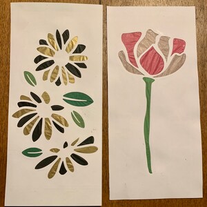 May include: Two cards with paper flower cutouts. The card on the left has three black and gold flowers with green leaves. The card on the right has a single pink flower with a green stem and leaves.