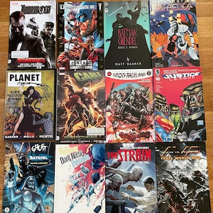 May include: A collection of fifteen graphic novels with various covers, including titles like "Thunderbolts," "Batman Grendel," and "Justice League." The image features a variety of comic book art styles and character designs, with the text "Five Random Graphic Novels" at the top.