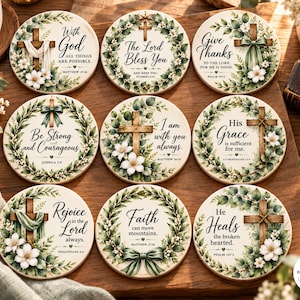May include: Nine round ceramic coasters featuring botanical wreaths, wooden crosses, and religious text including With God All Things Are Possible, The Lord Bless You, Give Thanks, Be Strong and Courageous, and He Heals the Broken Hearted.