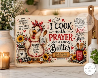 May include: A rectangular wooden cutting board featuring a cartoon chicken wearing a red polka dot headscarf and apron. The text reads: I COOK with PRAYER AND A LOT OF Butter, along with other phrases like Chicken Soup for the Soul and Matthew 6:11.