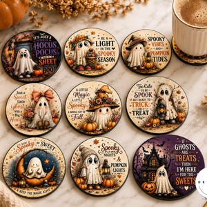 May include: A set of nine round drink coasters featuring various illustrations of ghosts, pumpkins, and autumn-themed motifs with printed text such as It's Just a Bunch of Hocus Pocus, Be a Light in the Spooky Season, and Spooky Vibes and Pumpkin Tides.