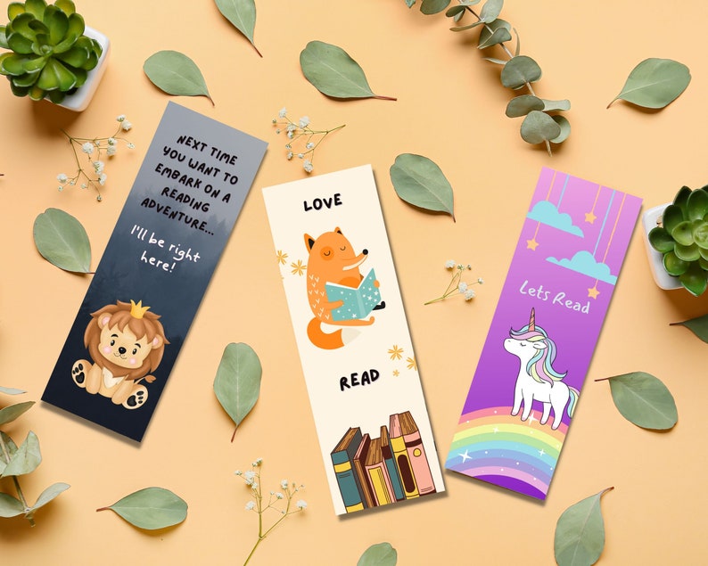 May include: Three colorful bookmarks with illustrations and text. One bookmark features a lion with the text "Next time you want to embark on a reading adventure... I'll be right here!". Another shows a fox reading with the words "LOVE READ". The last one has a unicorn and the words "Lets Read".