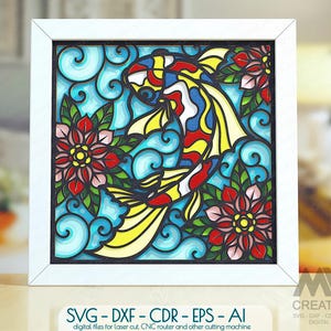 May include: A square white frame containing a multi-layered art piece featuring a colorful koi fish swimming among blue swirling water patterns and red flowers. The design mimics stained glass with bold black outlines and vibrant colors.