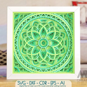 May include: A green and white mandala design in a white frame. The design is layered and intricate, with a variety of shapes and patterns. The mandala is perfect for laser cutting or CNC routing.