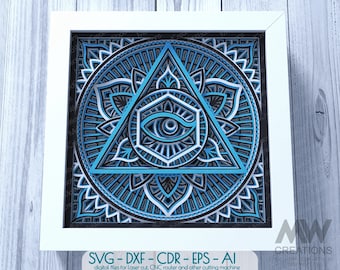 May include: A blue and white mandala design with an all-seeing eye in a triangle. The design is framed in a white frame. SVG-DXF-CDR - EPS - AI digital files for laser cut, CNC router and other cutting machine.