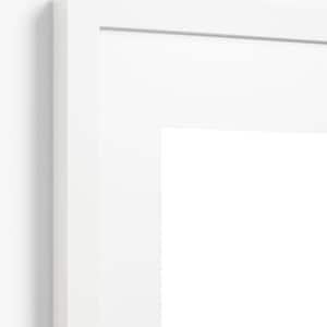 May include: A close-up of a white picture frame with a white mat. The frame is rectangular with a clean, modern design. The frame is mounted on a white wall.
