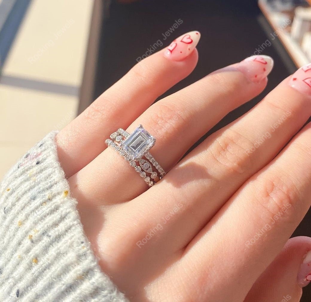 Emerald cut trio engagement ring discount