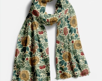 May include: A rectangular scarf with a floral pattern featuring sunflowers, red berries, and green leaves on an off-white background. The scarf has fringed edges and is made of a soft, flowing fabric. The design is reminiscent of vintage botanical illustrations.