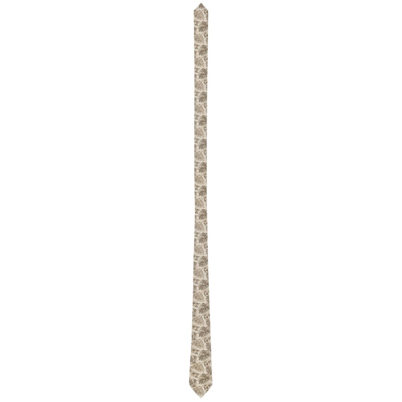 May include: A beige necktie with a repeating pattern of stylized, light brown leaves. The tie is vertically oriented against a white background, showcasing its design and texture. The tie's pointed end is visible.