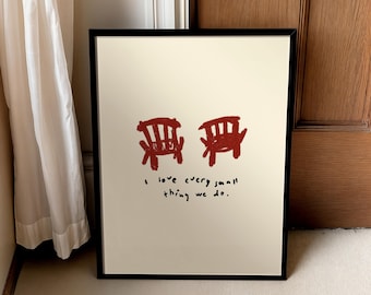 May include: Framed art print featuring two red chairs and the handwritten text, "I love every small thing we do." The artwork has a minimalist style with a cream-colored background and a black frame.