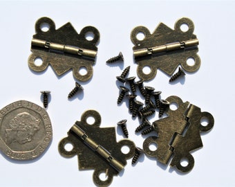 May include: An assortment of antique brass-colored hinges and screws, ideal for small woodworking projects or decorative applications. The hinges have a decorative shape with rounded edges and a central folding mechanism. A coin is included for size reference.