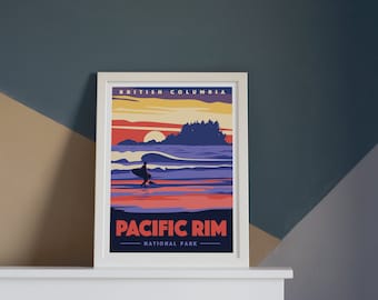 May include: A framed poster with a retro design featuring a sunset over the ocean with a surfer in the foreground. The poster reads "BRITISH COLUMBIA PACIFIC RIM NATIONAL PARK".