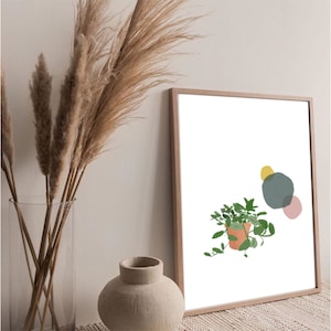 May include: A framed print with a minimalist design featuring a potted plant with green leaves and abstract shapes in yellow, blue, and pink.