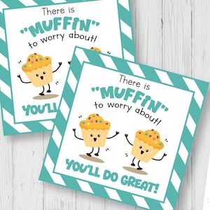 May include: Square tags with a teal and white striped border and the text "There is 'MUFFIN' to worry about! YOU'LL DO GREAT!" feature a cartoon muffin. The tags are 2.3 x 2.3 inches. The image also shows a sheet of tags and scissors.