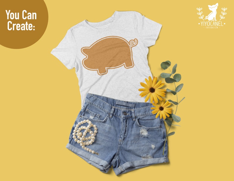 May include: A light gray short-sleeve t-shirt featuring a brown pig silhouette graphic, paired with blue denim shorts, a string of white pearls, and two yellow flowers. The text "You Can Create:" appears in the upper left corner of the image.