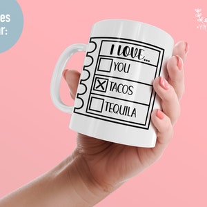 May include: White ceramic mug with a black outline of a checklist. The checklist says "I love..." with three options: "You", "Tacos", and "Tequila". The option for "Tacos" is checked with an "X".