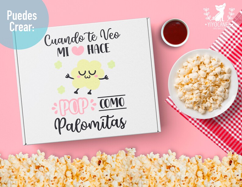 May include: A white box with the text "Cuando te veo mi coraz&oacute;n hace pop como palomitas" in black and pink lettering. The box has a cartoon popcorn with a face and stars around it. The box is on a pink background with a bowl of popcorn and a small bowl of red sauce.