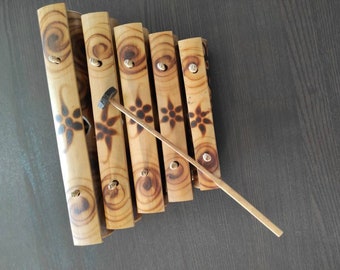 Hand-made bamboo Xylophone with 1 beating stick. Percussion musical instrument. 5 notes xylophone