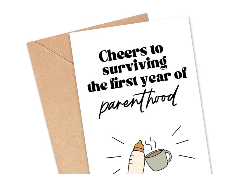 May include: A white card with black text that reads "Cheers to surviving the first year of parenthood". A black and white illustration of a baby bottle and a coffee cup is below the text.