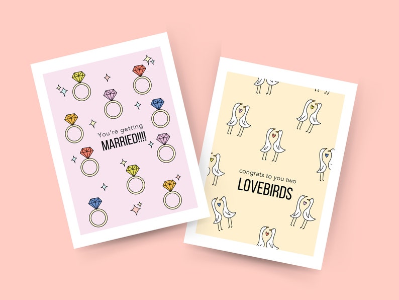 May include: Two wedding cards. The first card has a pink background with colorful diamond rings and the text "You're getting MARRIED!!!". The second card has a yellow background with a pattern of white birds with hearts and the text "congrats to you two LOVEBIRDS".