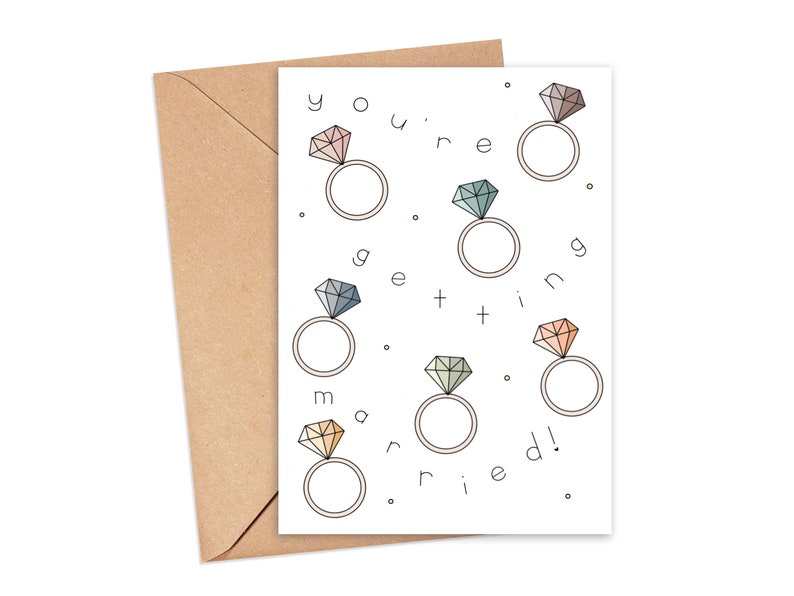 May include: A white card with the text "You're getting married!" surrounded by illustrations of rings with diamonds in various colors.