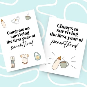 May include: Two white cards with black text and illustrations. The first card says "Congrats on surviving the first year of parenthood" and has illustrations of a baby bottle, a diaper, a cup of coffee, a stack of alphabet blocks, a baby onesie, and a baby rattle. The second card says "Cheers to surviving the first year of parenthood" and has illustrations of a baby bottle, a cup of coffee, and steam.