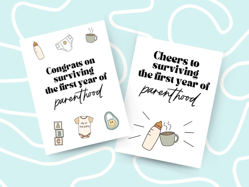 May include: Two white cards with black text and illustrations. The first card says "Congrats on surviving the first year of parenthood" and has illustrations of a baby bottle, a diaper, a cup of coffee, a stack of alphabet blocks, a baby onesie, and a baby rattle. The second card says "Cheers to surviving the first year of parenthood" and has illustrations of a baby bottle, a cup of coffee, and steam.
