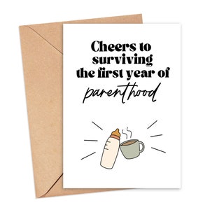 May include: A white card with black text that reads "Cheers to surviving the first year of parenthood". A black and white illustration of a baby bottle and a cup of coffee is below the text.