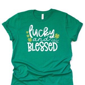 May include: Green t-shirt with the text "lucky and blessed" in white with gold shamrocks.