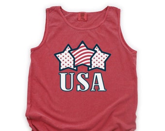 May include: Red sleeveless tank top with a graphic of three stars in red, white, and blue with the word "USA" underneath.