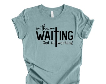 May include: A light blue t-shirt with a black graphic that says "in the ♥ waiting God is working" with a cross.