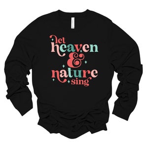 May include: Black long-sleeve shirt with the text "Let heaven & nature sing" in pink and teal lettering.