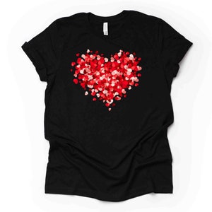 May include: Black t-shirt with a red and pink heart made of smaller hearts.