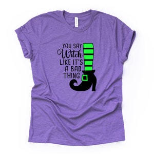 May include: Purple t-shirt with a black and green witch boot graphic and the text "You say Witch like it's a bad thing".