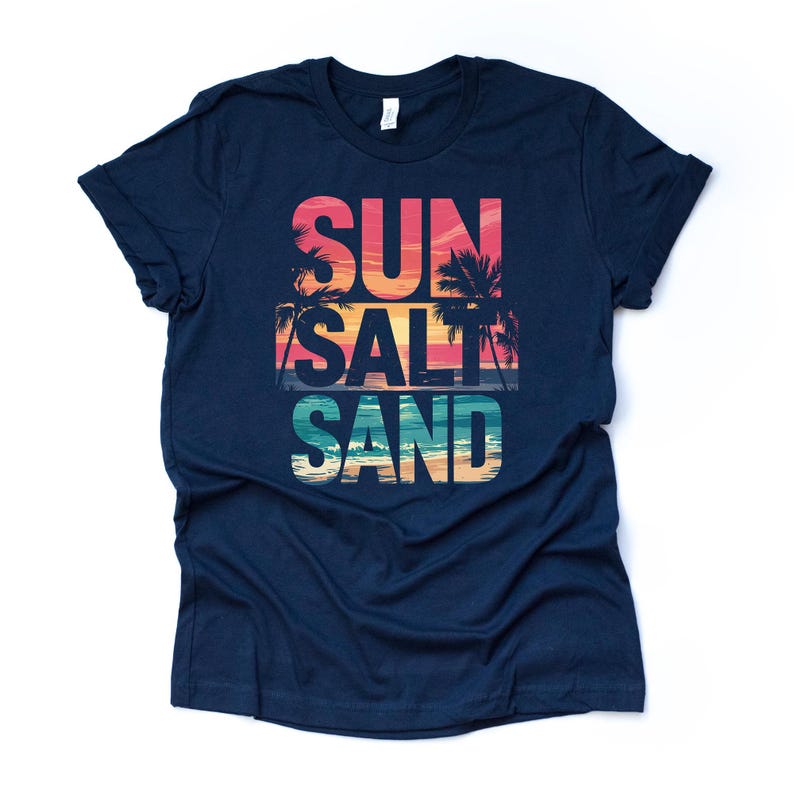 Op de afbeelding: Marineblauw T-shirt met de woorden "SUN SALT SAND" in een kleurrijk ontwerp. De tekst bevat een zonsondergang en palmbomen, met een strandsc&egrave;ne aan de onderkant. Een casual t-shirt voor strandliefhebbers.