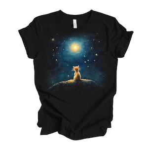May include: A black t-shirt with a graphic of a yellow cat sitting on a hill and looking up at a bright moon and stars in the night sky.