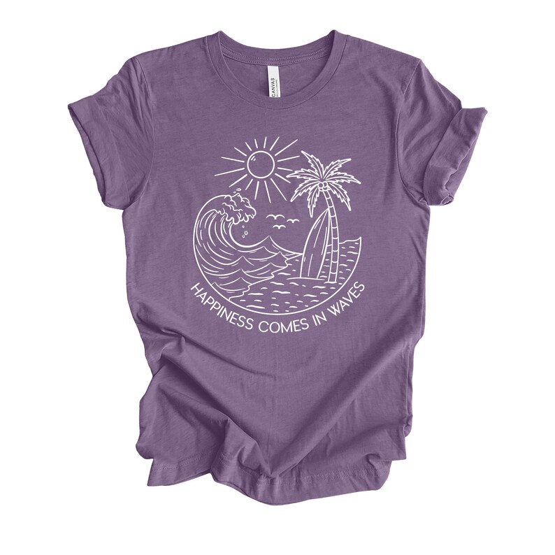 May include: Purple t-shirt with a white graphic of a wave, palm tree, surfboard, and sun. The text "Happiness comes in waves" is written below the graphic.