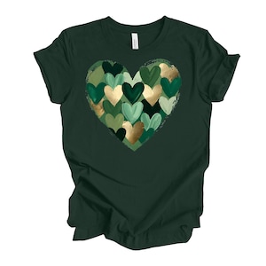 May include: Dark green t-shirt featuring a heart design composed of various shades of green and gold hearts. The heart is centered on the shirt, creating a visually appealing graphic. The shirt is made of a soft material.