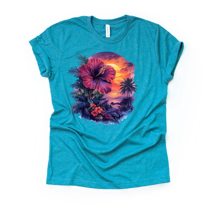 May include: A turquoise t-shirt featuring a vibrant tropical design. The graphic showcases a large, deep pink hibiscus flower, palm trees, and a sunset over the ocean. The shirt is made of a soft material and has a classic crew neck.