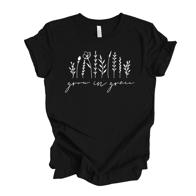 May include: Black t-shirt with a white graphic of stylized flowers and the text "grow in grace".